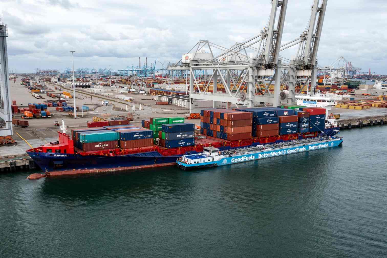 An aerial photo of a container vessel receiving sustainable biofuels by a GoodFuels biofuel barge.